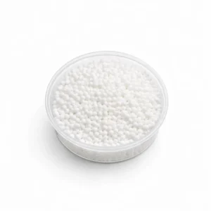Calcium nitrate fertiliser granules in white pellet form in clear container on white background