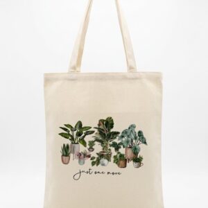 Large canvas tote bag with botanical plant print and “just one more” text on neutral background