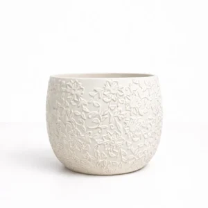 White floral pattern pot with embossed flower design in matte white finish on white background