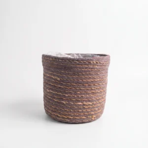 Grey woven seagrass basket cover pot 22cm with natural woven texture and protective plastic liner on white background