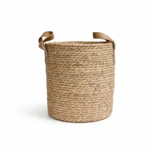 Large woven seagrass basket with brown faux leather handles and protective liner for indoor plants on white background