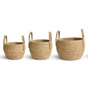 Round thick woven seagrass basket small with integrated handles and protective liner on white background